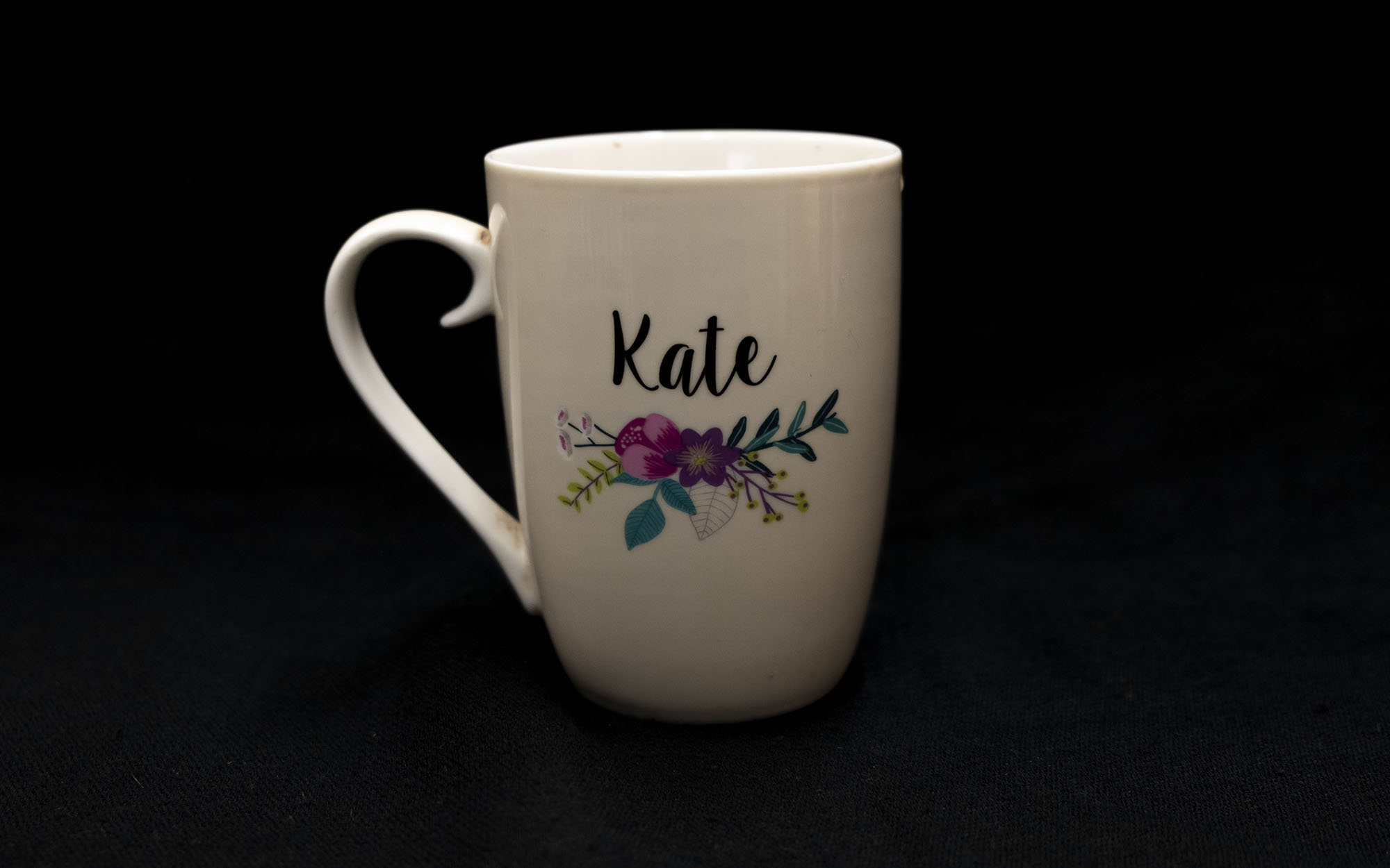 Large cup that says "Kate" and has a picture of flowers on it