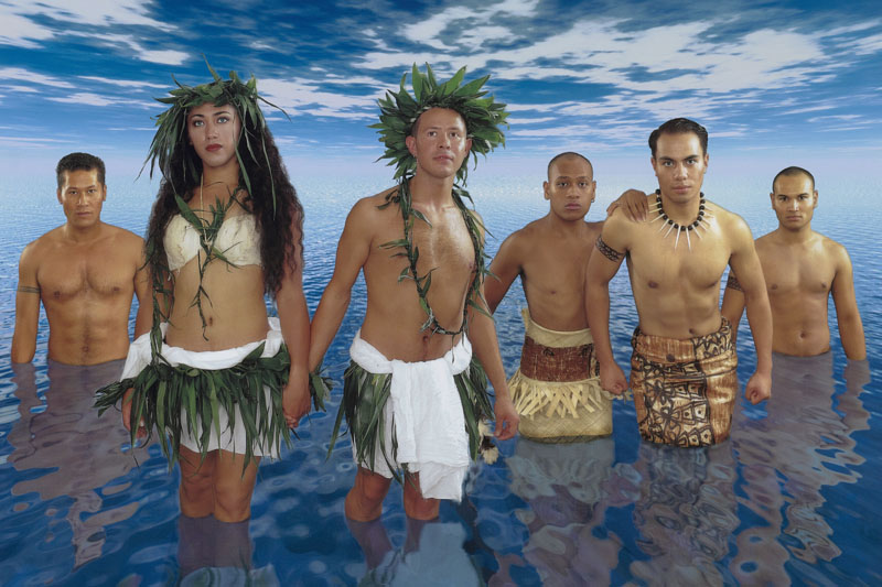 Crop from a poster featuring six people in traditonal Pacific clothing standing in a vast expanse of water with a vast skuy above them.