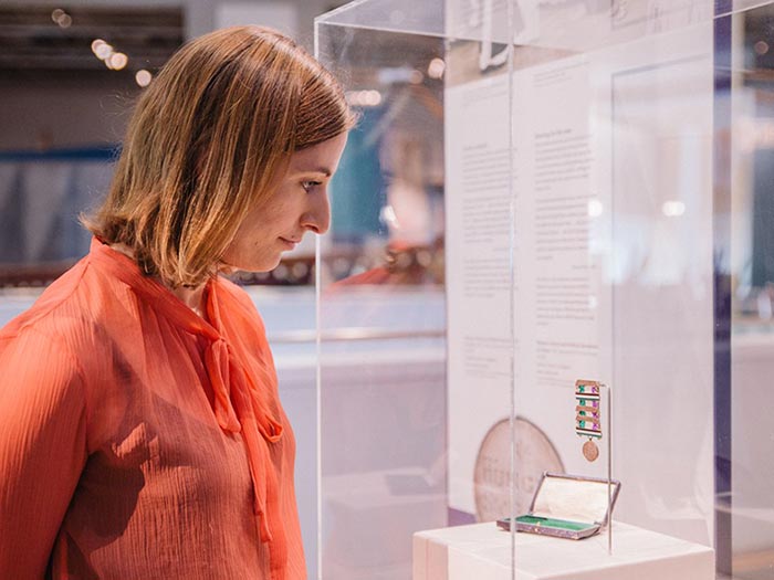 Woman looks at medal