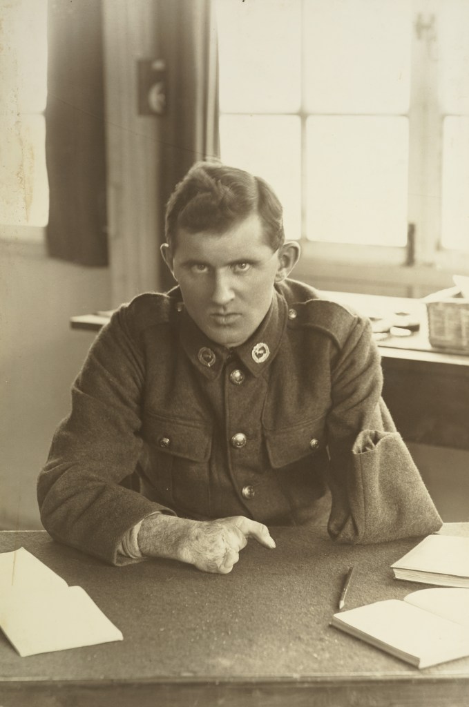 One-armed soldier sits at a desk