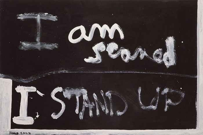 White painted text on black background "I am scared I stand up"