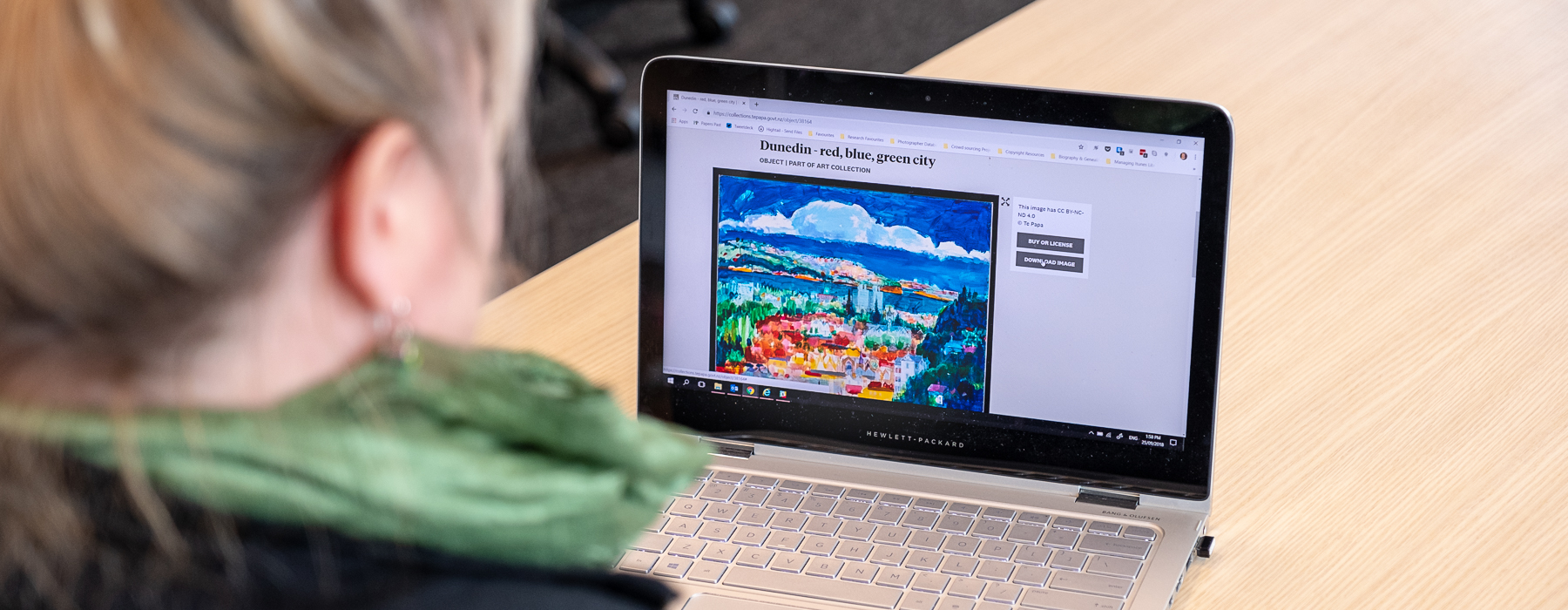 A person on a laptop looking at images on Te Papa's Collections Online website