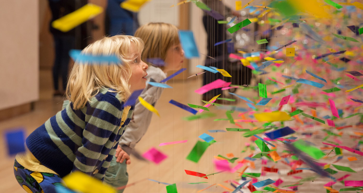 Kids staring intently at an artwork