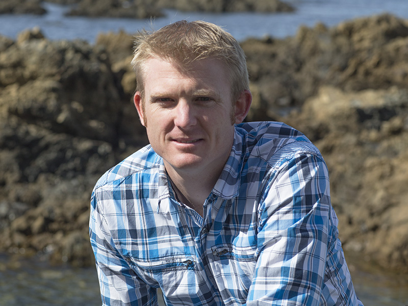 Close up of a man on a beach looking at the camera