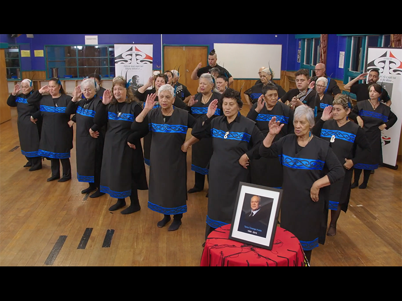 A group of people in a large room dancing with actions