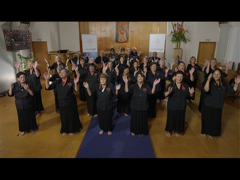 People standing in a group dancing in formation