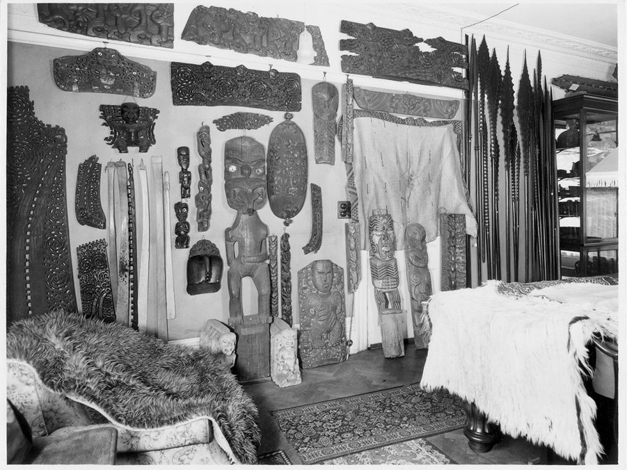Black and white photo of Pacific carvings and collection items