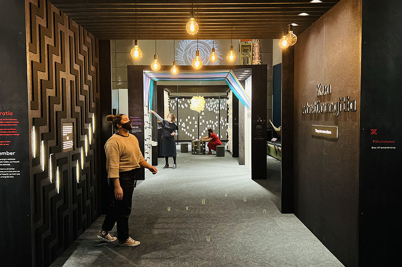 Three people explore the three areas in the Matariki Experience at Te Papa