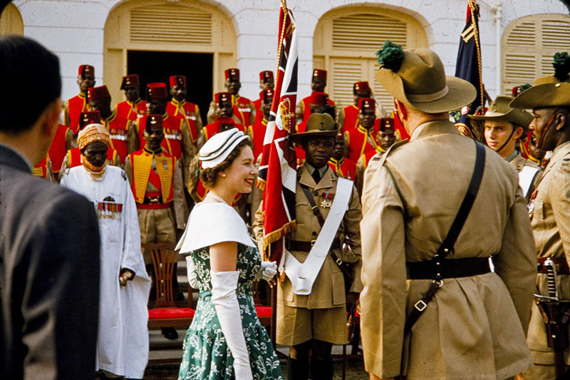 Queen Elizabeth II stands in front of a large group of soldiers