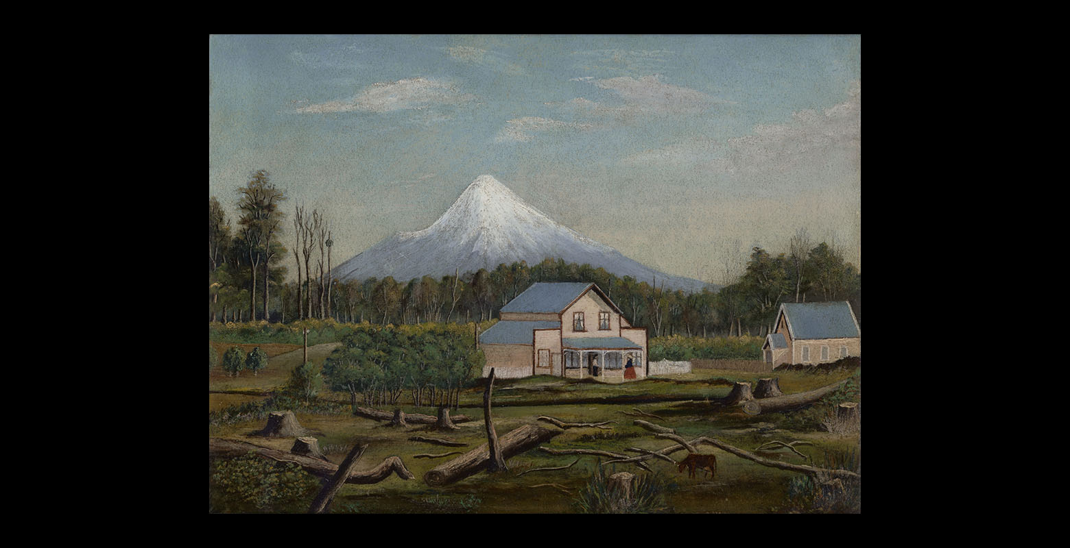 View of two buildings, a homestead and a church, surrounded by felled trees. Behind them a dense forest, and behind that forest stands Mt Taranaki, dominating the distant view