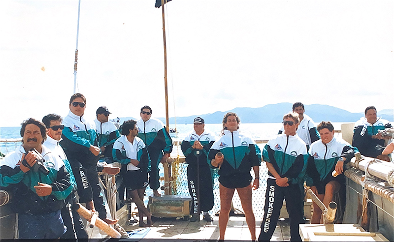 12 People standing on the deck of a boat