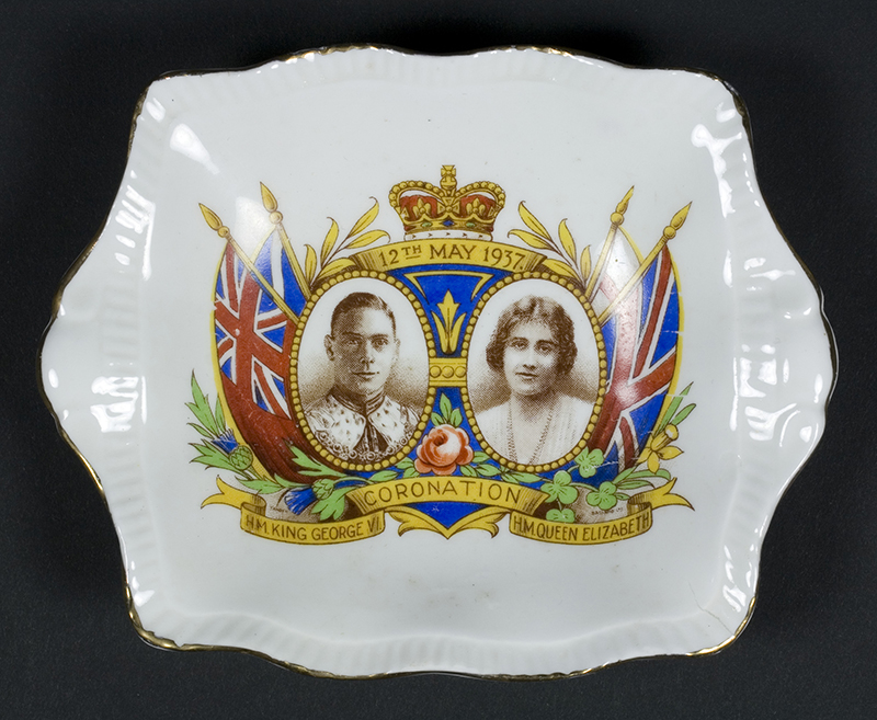 A dish with scalloped edges and a print of the head and shoulders of King George and his wife Elizabeth.