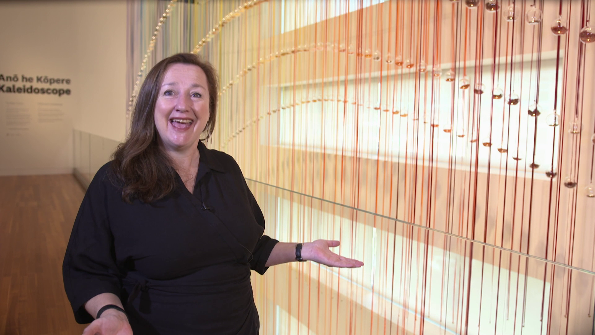 A woman standing in front of a colourful art installation