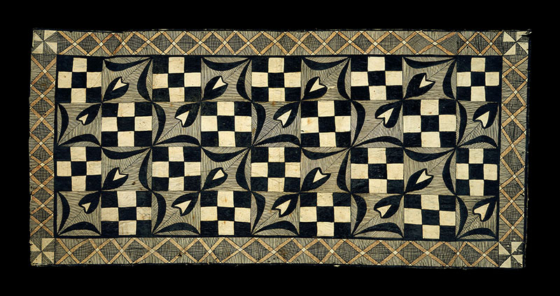 Tapa cloth. The border is a network of orange Xs, while the internal patterns alternate between checkerboards and flowers